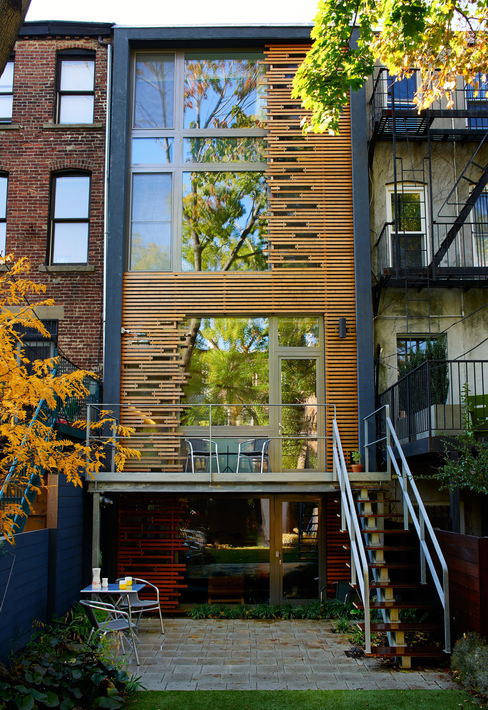 exterior view of the back of a townhouse with wood detailing design by Sarah Jefferys Architecture + Design