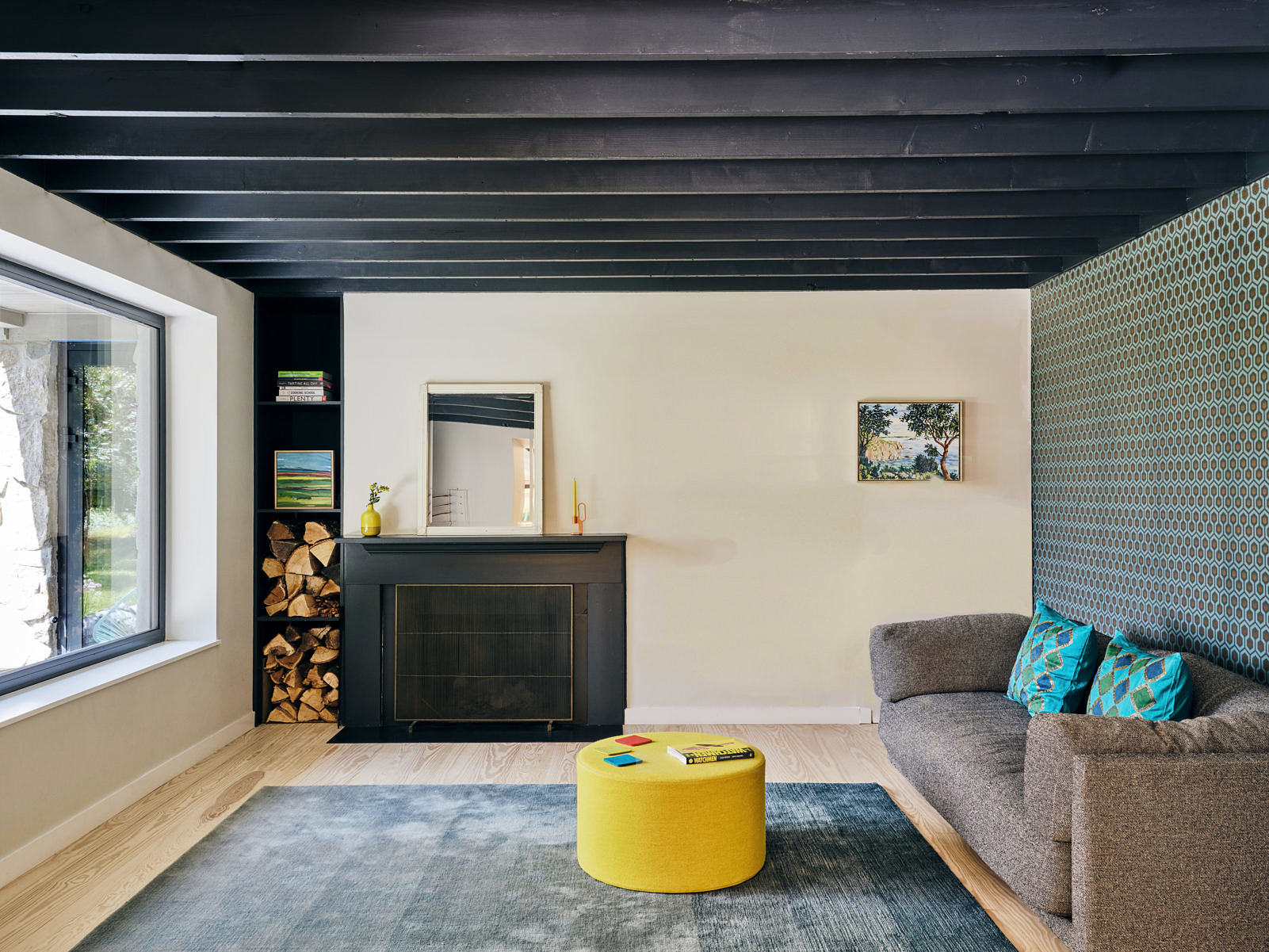 interior shot of living room and fireplace in Modern passive house design by SJDNY