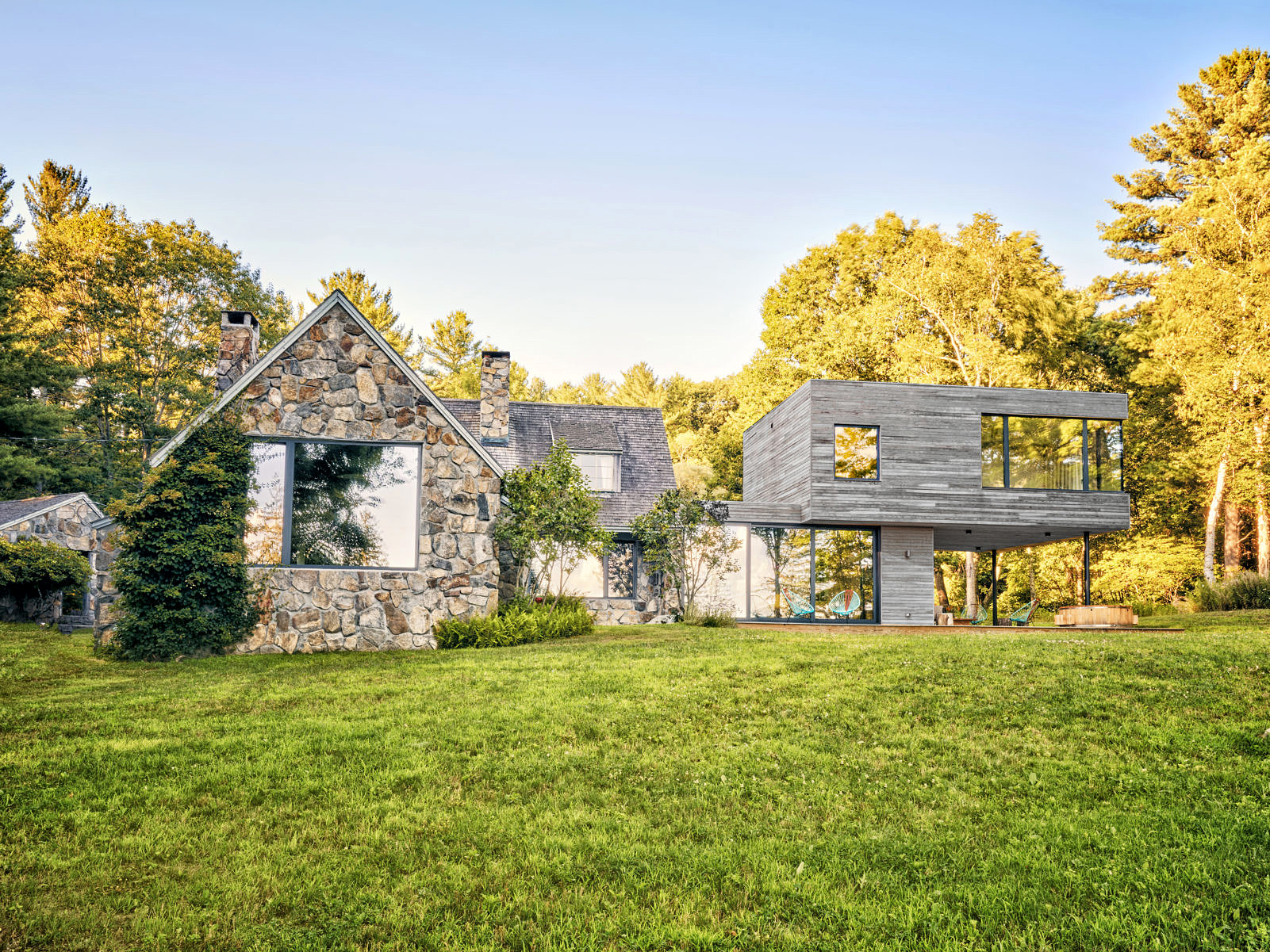 exterior view of traditional new england cottage with modern passive house addition
