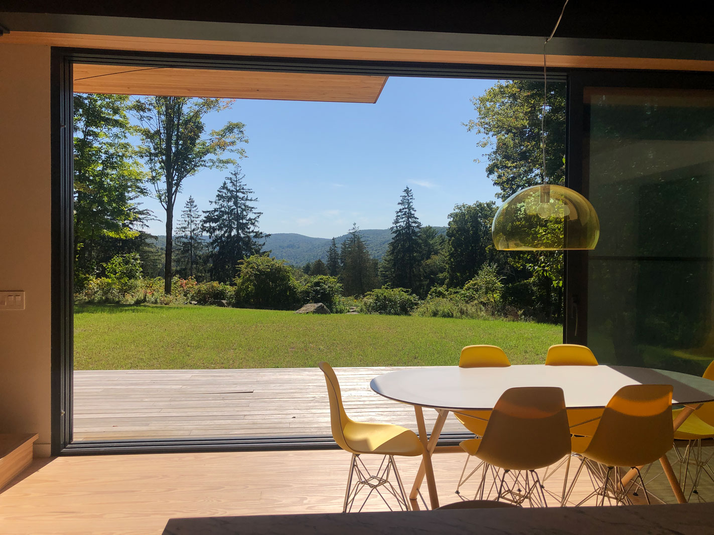 view of mountains from dining area in modern passive house by new england interior designer sarah jefferys