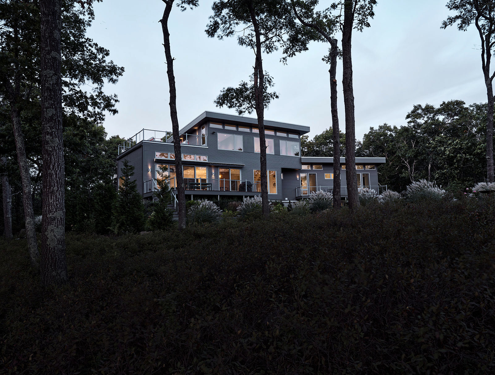 exterior shot of ocean view house at night in Charlestown, RI- architecture by Sarah Jeffry's Architecture + Design