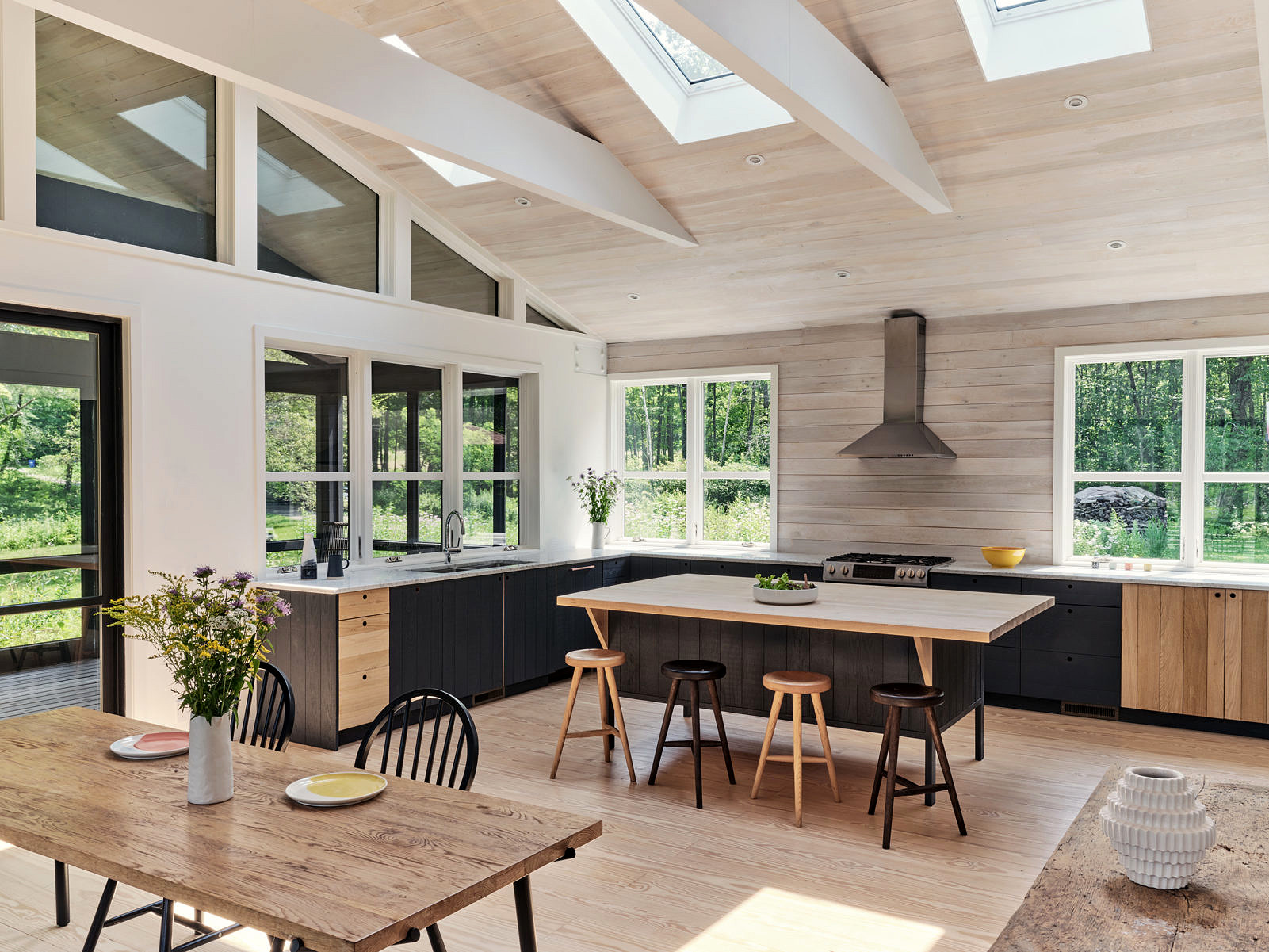 Dining room and kitchen in rustic home addition by connecticut architect sarah jefferys